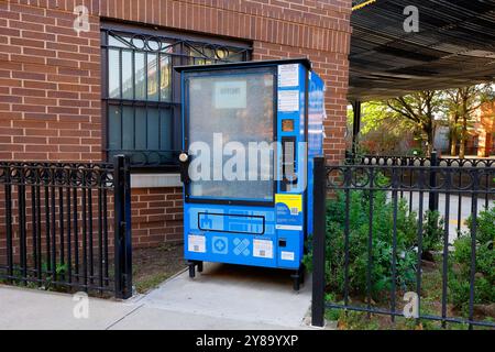 An offline, smashed, vandalized NYC Public Health Vending Machine dispensing opioid overdose rescue kits containing Nalonone, toiletries, and condoms. Stock Photo