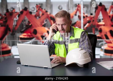 Man At Car Production Factory In Stress. Sad Technician Stock Photo