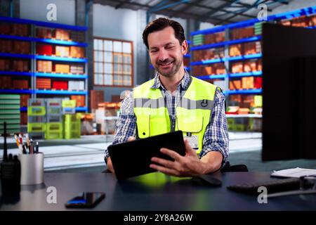 Warehouse Worker And Manager Checking Inventory In Warehouse Stock Photo