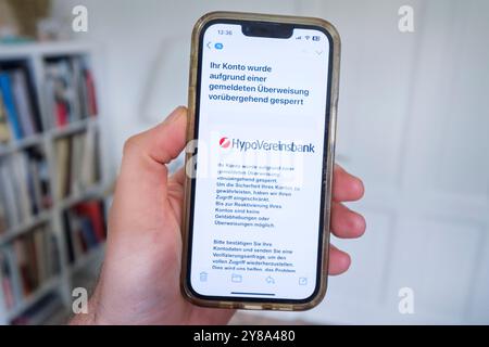Fraudulent phishing email on a mobile phone reporting an alleged account blocking at HypoVereinsbank Stock Photo