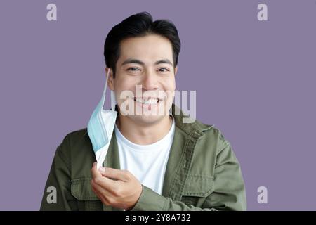 Smiling Man Taking The Mask Off Stock Photo
