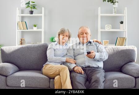 Retired old senior couple, gray hair elderly loving old aged family couple relaxing on couch at home Stock Photo