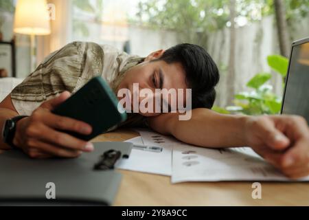 Tired Man Using His Mobile Phone Stock Photo