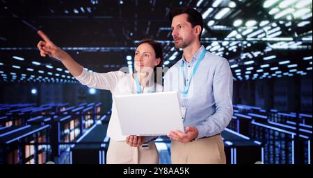 Server Room In Data Center. Cloud Computer Engineers Configuring AI Technology Stock Photo