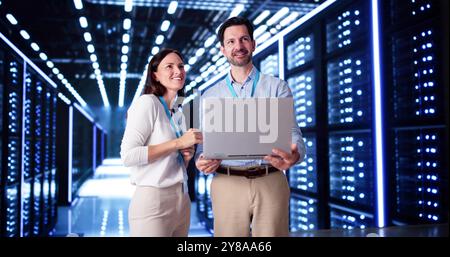 Server Room In Data Center. Cloud Computer Engineers Configuring AI Technology Stock Photo