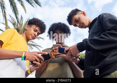 teen friends having fun using mobile phones Stock Photo