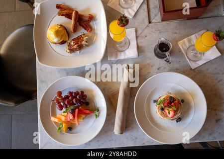 Colorful variety of breakfast foods on table from above Stock Photo