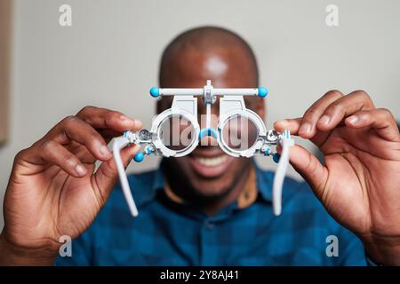 Optometrist Holding Trial Frame in Optical Clinic for Vision Testing Stock Photo