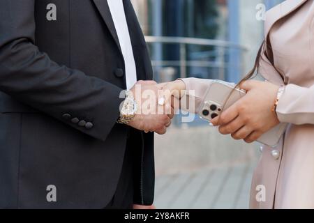 Professional Handshake Between Two Individuals in Business Attire. Stock Photo