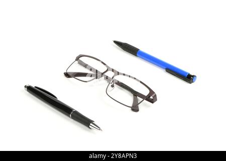 Business blue and black ballpoint pen with reading glasses isolated on white background. Office and secretarial concept. High resolution photo. Full d Stock Photo