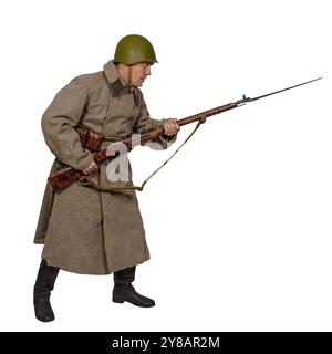 A sergeant of the 10th NKVD Rifle Division attacks in winter uniform. USSR. The Second World War. Isolated on white Stock Photo