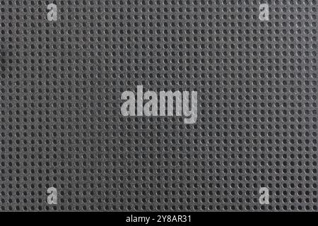 Polka dot plastic texture background. Many polka dots on a black plastic background with vintage style. Stock Photo