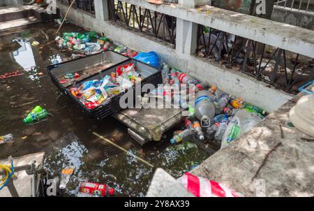 Manila, Philippines - August 26, 2019: Litter-filled canal exposing environmental neglect in an urban area during daylight hours Stock Photo
