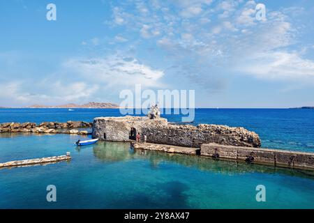 Serene view of the medieval Venetian fortress in Naousa, Paros, Greece, with calm turquoise waters and a picturesque coastal landscape Stock Photo