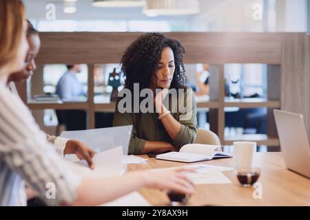 Meeting, notebook and business people in office with startup company for creative magazine. Research, discussion and team of editorial managers Stock Photo