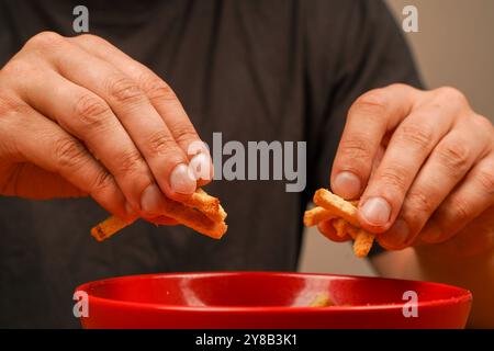Snack. Cholesterol. Fast carbohydrates. Salty snack for beer. Unhealthy food. Croutons. Croutons in bowl. Junk food. Unhealthy food for figure, heart Stock Photo