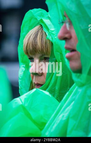 HOODS UP, SUMMER STORM, BEACH VOLLEYBALL, MARIEHAMN, 2011: The eyes have it. It's hoods up when the rain gets really heavy. The crowd cover up with disposable rain ponchos as a huge summer storm sweeps through the stadium with a deluge of rain during the semi-finals in August 2011 at the Paf Open in Mariehamn, Åland, Finland. Photograph: Rob Watkins.   INFO: Between 2009-2013 the PAF Open Beach Volleyball tournament was an annual event held in Mariehamn, Åland, Finland. It attracted the top international teams and players as a ranking part of the official FIVB World Tour, showcasing high-level Stock Photo