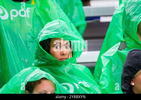 HOODS UP, SUMMER STORM, BEACH VOLLEYBALL, MARIEHAMN, 2011: It's hoods up for the Brazil fans when the rain gets really heavy. The crowd cover up with disposable rain ponchos as a huge summer storm sweeps through the stadium with a deluge of rain during the semi-finals in August 2011 at the Paf Open in Mariehamn, Åland, Finland. Photograph: Rob Watkins.   INFO: Between 2009-2013 the PAF Open Beach Volleyball tournament was an annual event held in Mariehamn, Åland, Finland. It attracted the top international teams and players as a ranking part of the official FIVB World Tour, showcasing high-lev Stock Photo