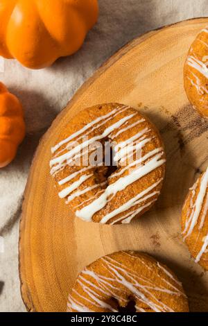 Sweet Homemade Pumpkin Spice Donuts with Icing and Cinnamon Stock Photo