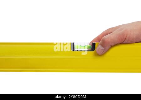 Hand holding yellow level tool isolated on white background Stock Photo