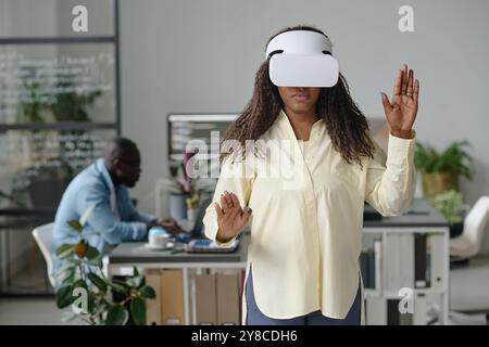 African American woman enjoying VR game in office of modern game developing company Stock Photo