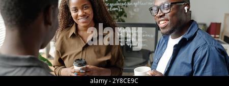 Website banner with young African American business team chatting with each other during coffee break Stock Photo