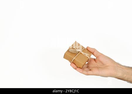 Man holding a gift package for valentine day or other special day celebration. Isolated on white background. Stock Photo