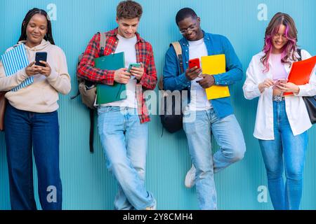For students having fun with mobile phones creating content on social media. Stock Photo