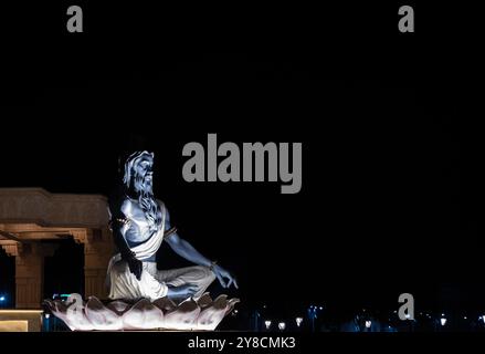 idols of hindu holy sage sitting in mediation at outdoor at night Stock Photo