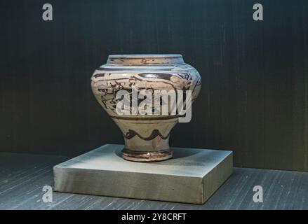 Ancient pottery decorated with intricate designs displayed in a museum exhibition highlighting historical artifacts Stock Photo