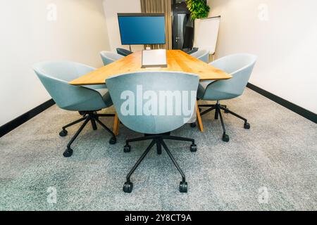 conference room table laptop office interior wooden table empty tv screen presentation Stock Photo