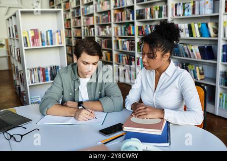 A patient educator assists her focused student with engaging lessons in the library. Stock Photo