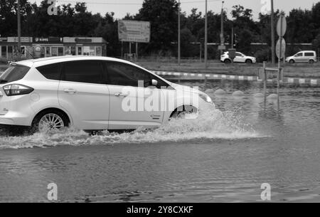 ODESSA, UKRAINE-September 5,2024: After heavy rains, traffic jams formed on roads, cars are doused with water and stall. Cars float in puddles on the Stock Photo