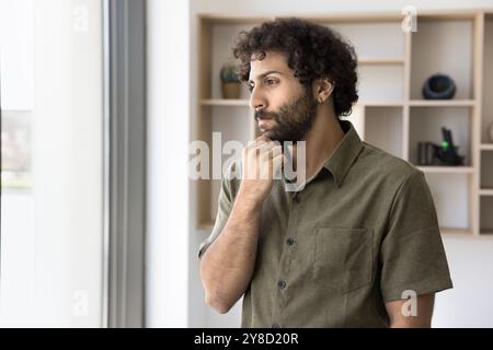 Pensive young businessman of Arabic ethnicity feel lost in thoughts Stock Photo