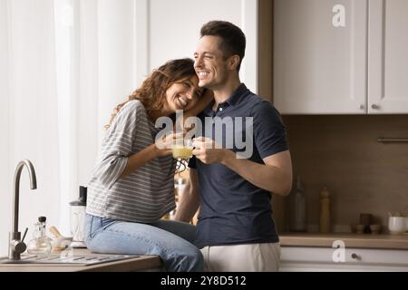 Happy married couple in love hugging in kitchen Stock Photo