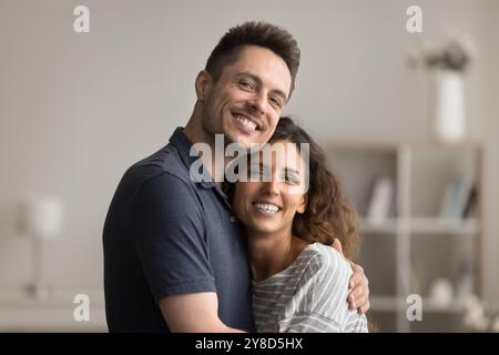 Happy positive young married couple hugging with love Stock Photo