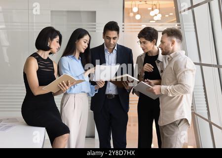 Diverse business team of focused coworkers analyzing document Stock Photo