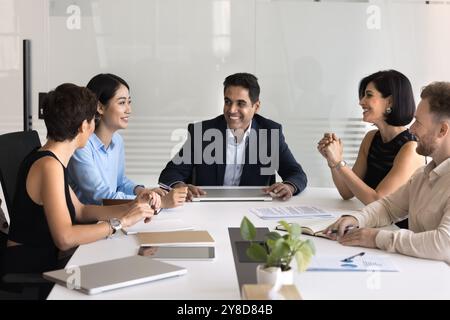 Happy middle aged Indian company director man holding meeting Stock Photo