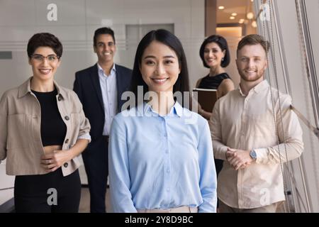 Happy young Asian professional woman posing for team leader portrait Stock Photo