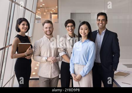 Successful diverse team of positive business colleagues standing in office Stock Photo