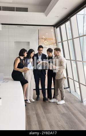Indian business leader and team of managers reading legal document Stock Photo