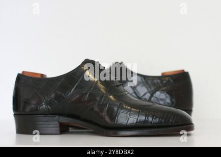 Premium British Handmade Bespoke Black Crocodile Shoes. Nile crocodile leather with wooden shoetrees. Stock Photo