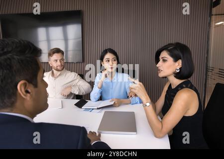 Confident attractive team leader woman speaking at meeting Stock Photo