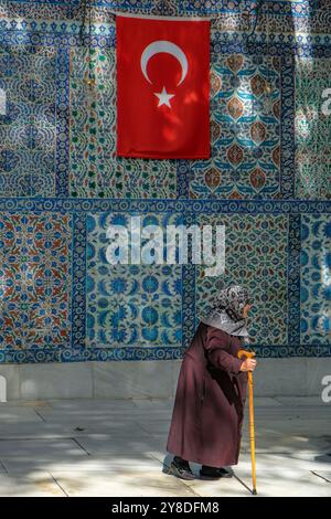 Istanbul, Turkey - September 23, 2024: A woman visiting the Eyup Sultan Mosque and the mausoleum of Abu Ayyub al-Ansari in Istanbul, Turkey. Stock Photo