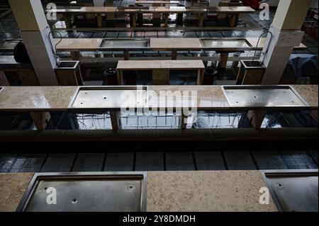 Empty market stalls with tiled counters and drainage, inside Funchal’s mercado dos lavradores Stock Photo