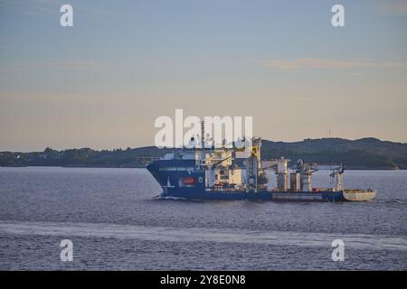 An oil rig supply ship sails off the coast of Bergen, on the North Sea, Bergen, Vestland, Norway, Europe Stock Photo