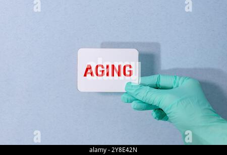 Smiling happy senior mature middle aged man holding cell mobile phone using smartphone sitting at home on couch, scrolling social media, checking fina Stock Photo