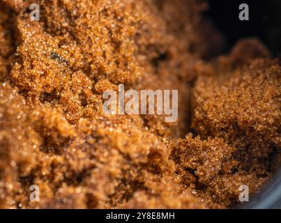 Close-up macro,almost abstract details of the fresh,sweet and sticky sugar grains,leading into a blurred black backdrop. Stock Photo