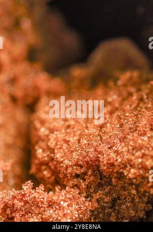 Close-up macro,almost abstract details of the fresh,sweet and sticky sugar grains,leading into a blurred black backdrop. Stock Photo