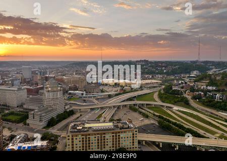 Aerial view of American highway junction at sunset with fast driving vehicles in Cincinnati city, Ohio. View from above of USA transportation infrastr Stock Photo